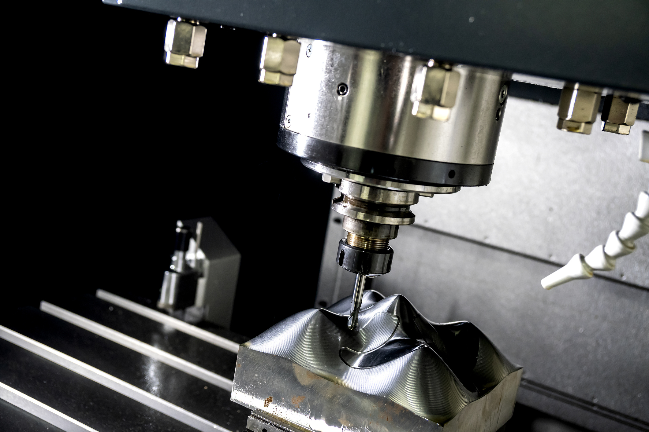 The  CNC milling machine cutting the mold part with the solid ball end mill tool.